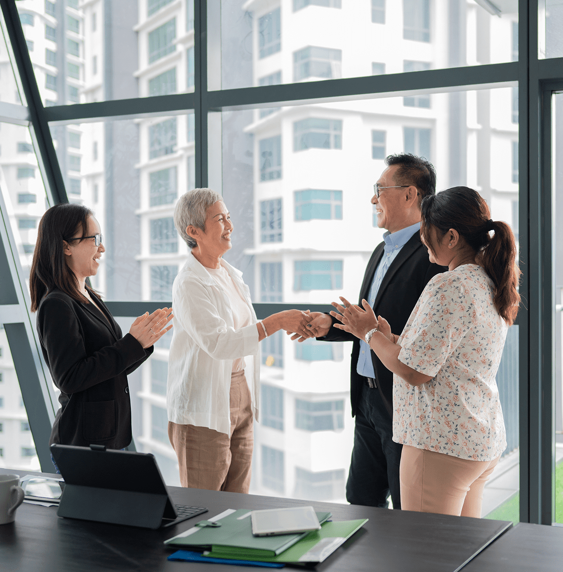 Business meeting handshake in modern office.