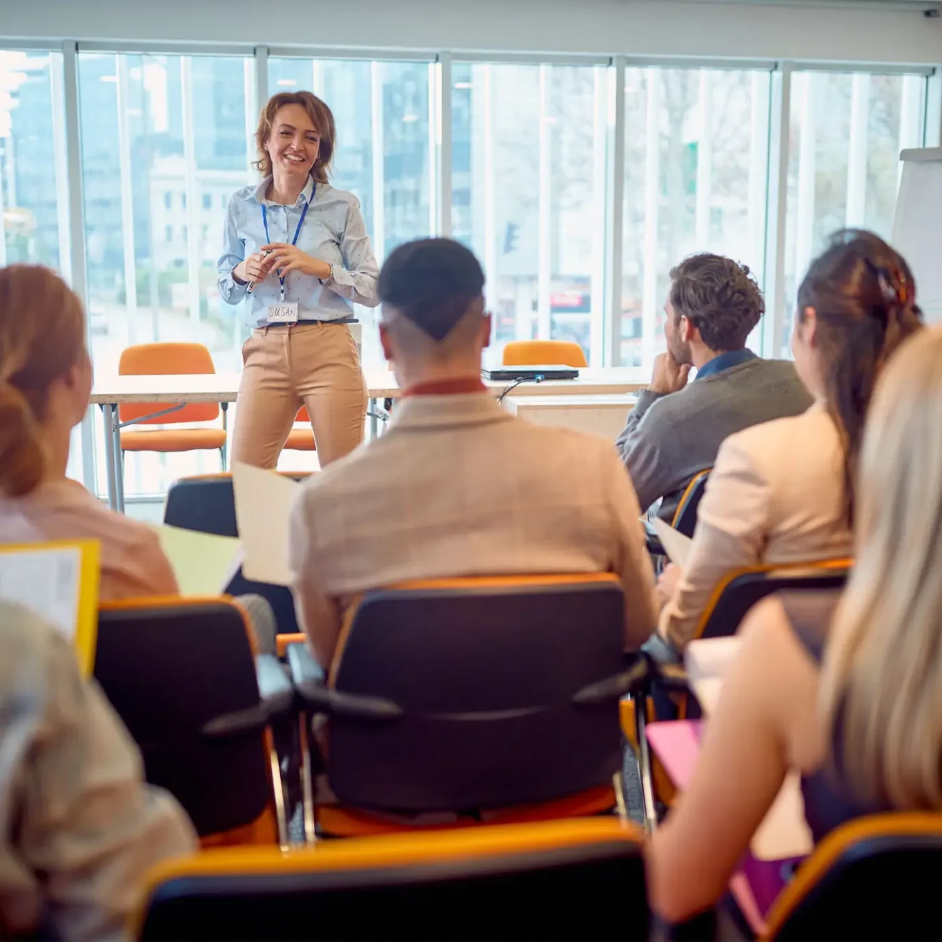 A woman conducting a meeting with her team